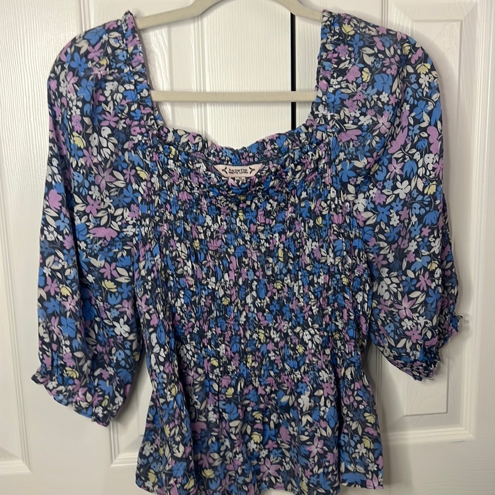 Flowery blouse with with stretchy material around the chest area.